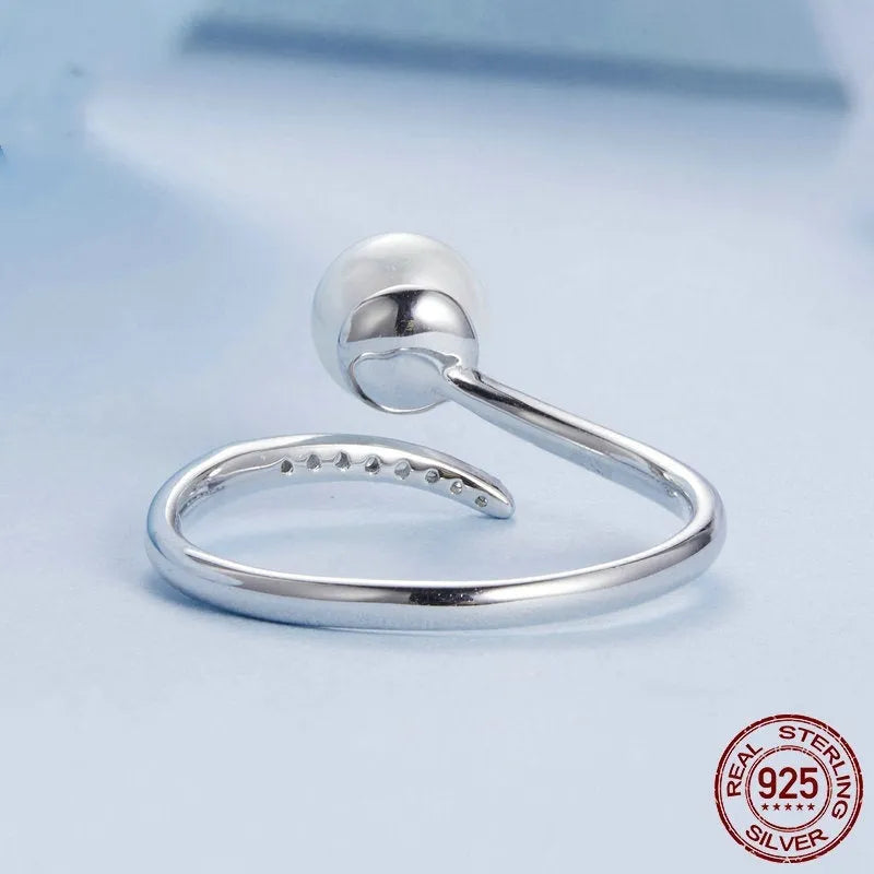 Adjustable S925 sterling silver ring for women featuring a natural shell pearl on an open loop band.