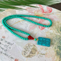 Hand-woven turquoise mesh flower lucky pendant on an adjustable ball bead necklace chain.