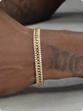 Gold titanium steel tennis bracelet with artificial gemstone inlay on wrist