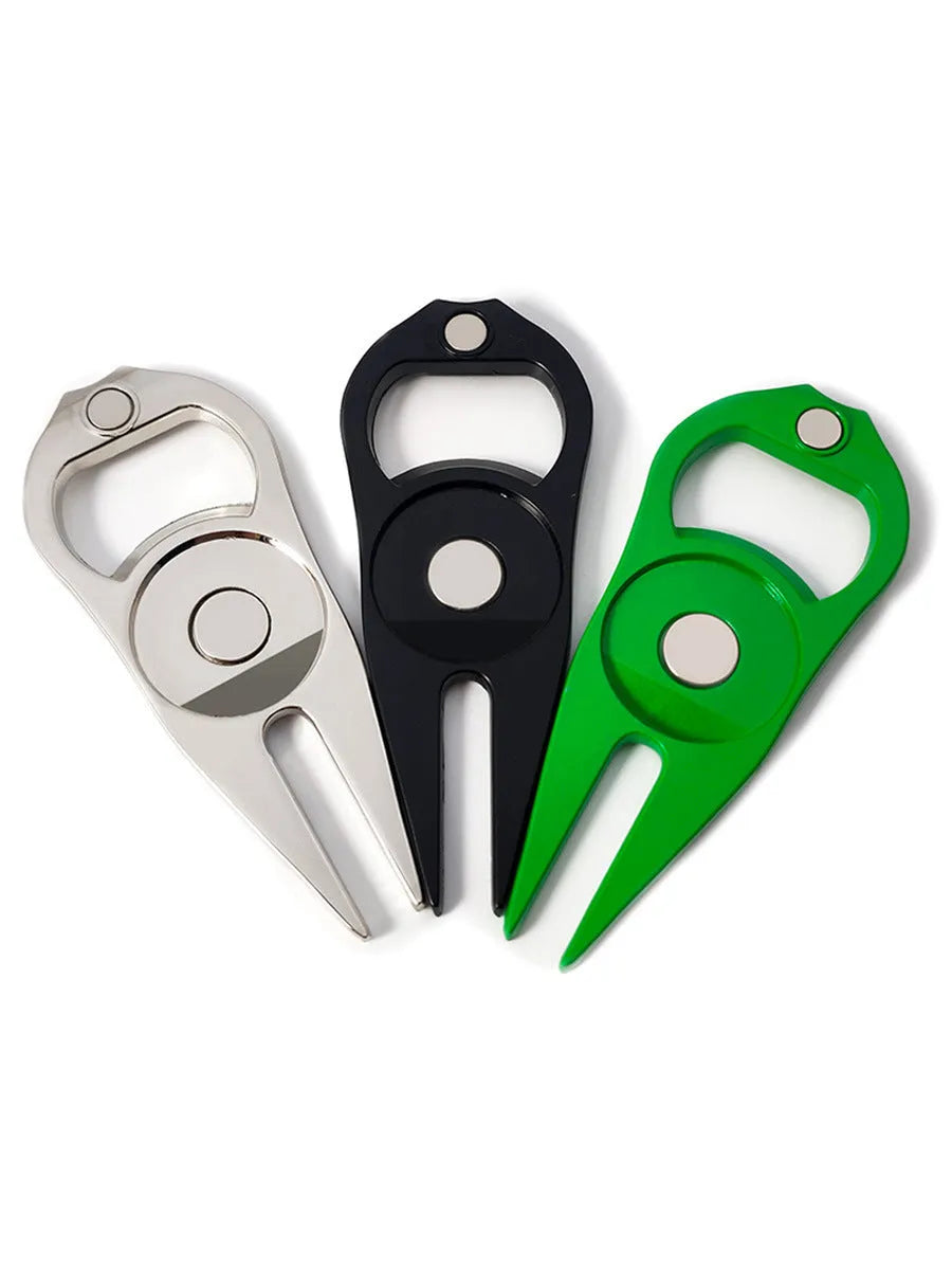 Black zinc alloy golf ball yoke fork with integrated bottle opener tool on green turf.