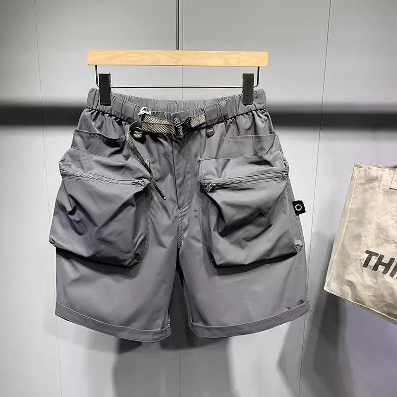 Men's loose-fitting black workwear shorts with pockets, featuring a non-iron finish and a mid-waist design.