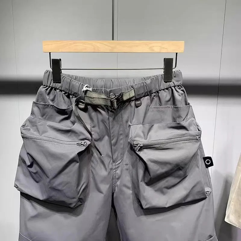 Men's loose-fitting black workwear shorts with pockets, featuring a non-iron finish and a mid-waist design.