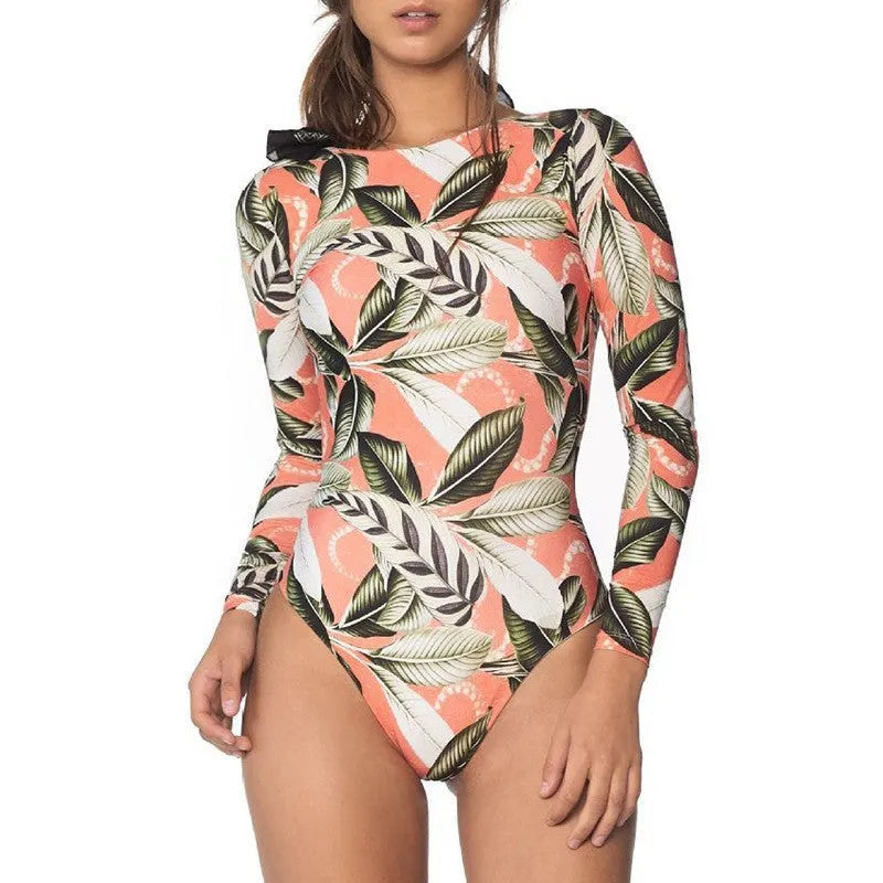 Backless one-piece swimsuit with green leaf floral print on black background