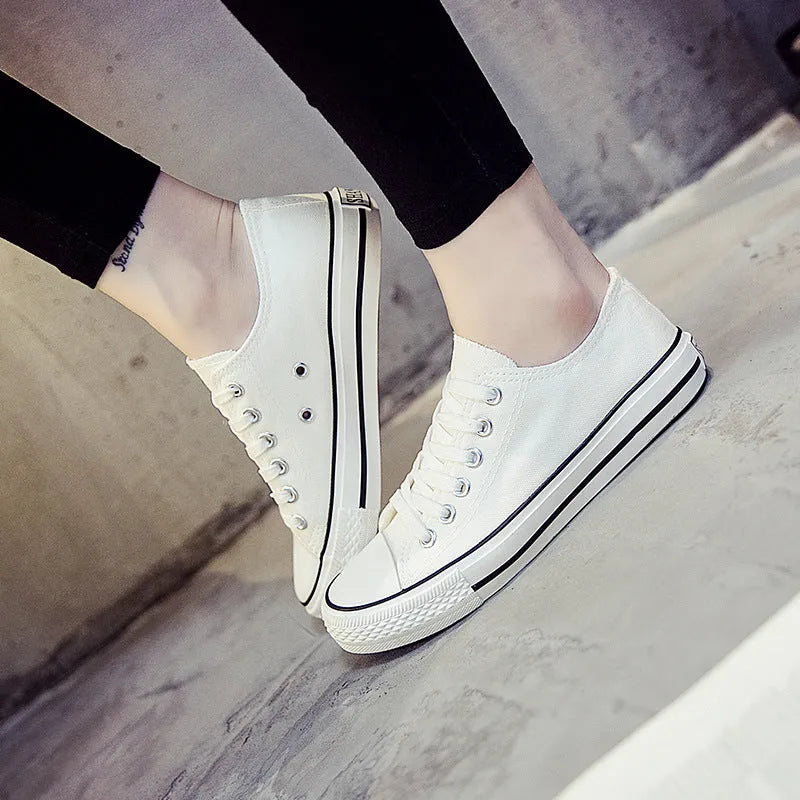 Solid colour women's canvas lace-up flats in black, shown on a white background.