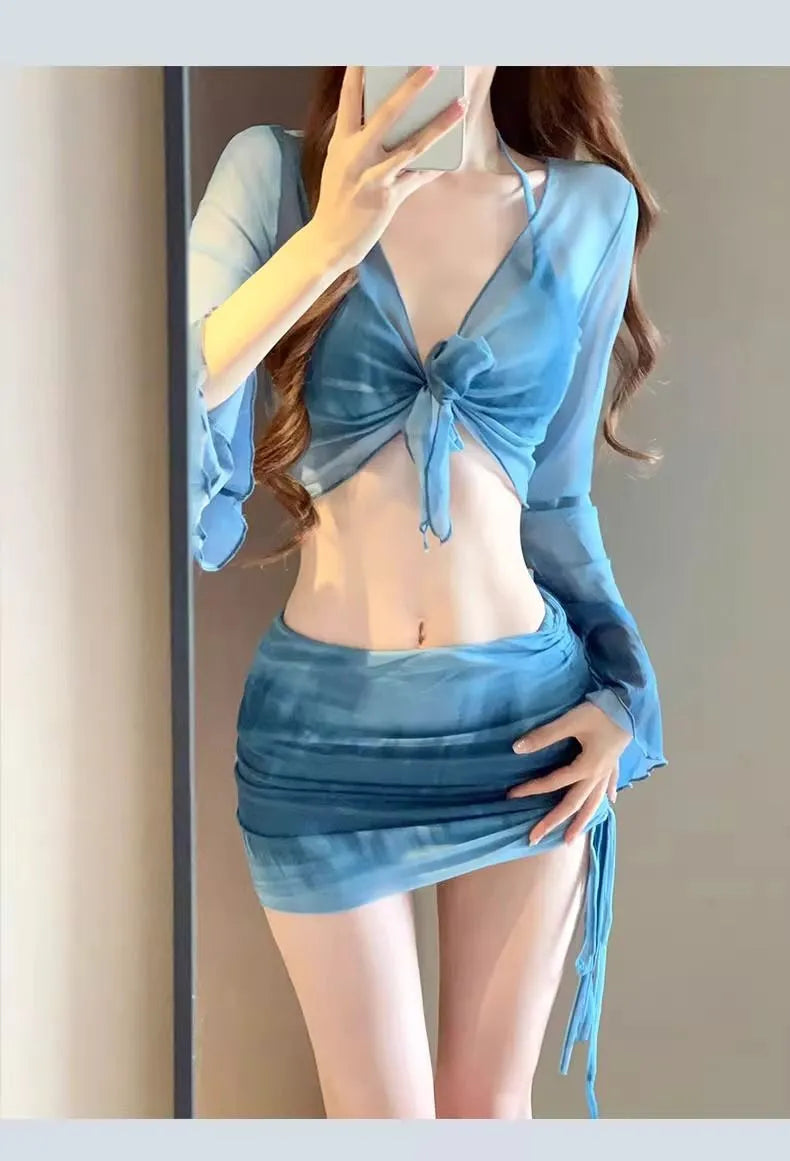 Women's blue four-piece bikini swimsuit set with high-waisted briefs, shirt, and skirt on mannequin