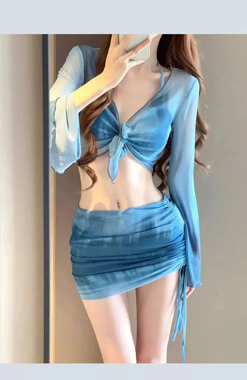 Women's blue four-piece bikini swimsuit set with high-waisted briefs, shirt, and skirt on mannequin
