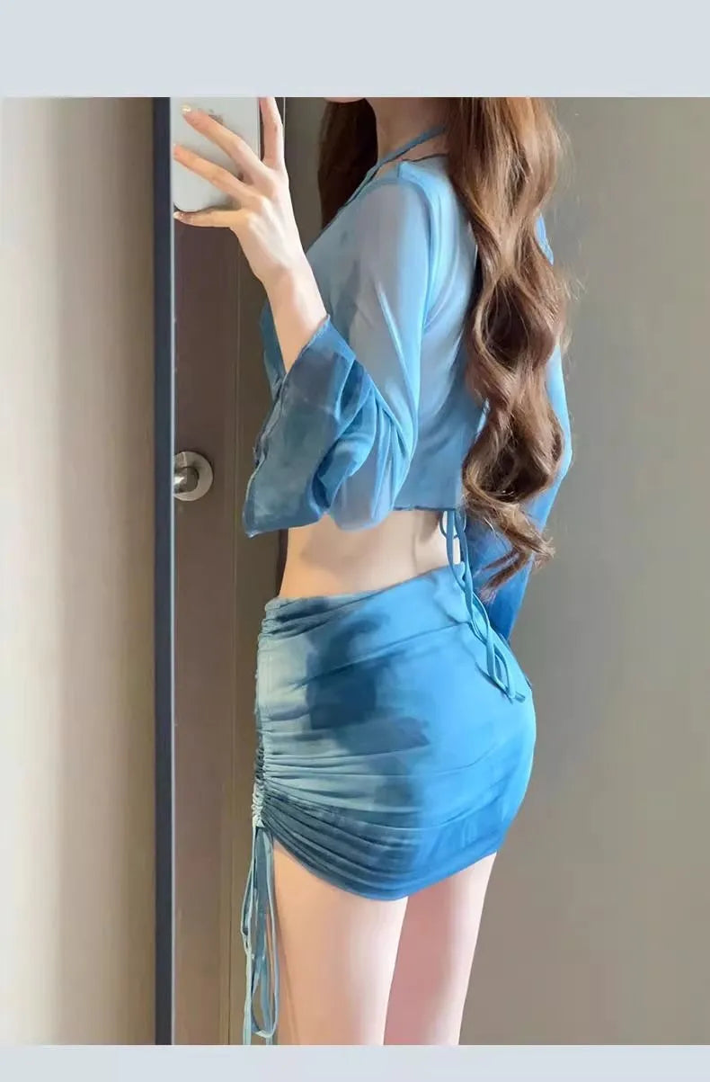 Women's blue four-piece bikini swimsuit set with high-waisted briefs, shirt, and skirt on mannequin