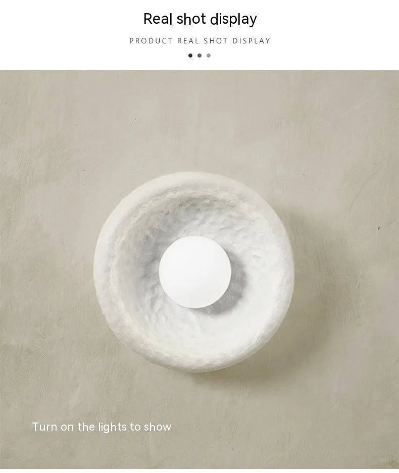 Japanese-style simple modern wall lamp with round resin shade in warm light