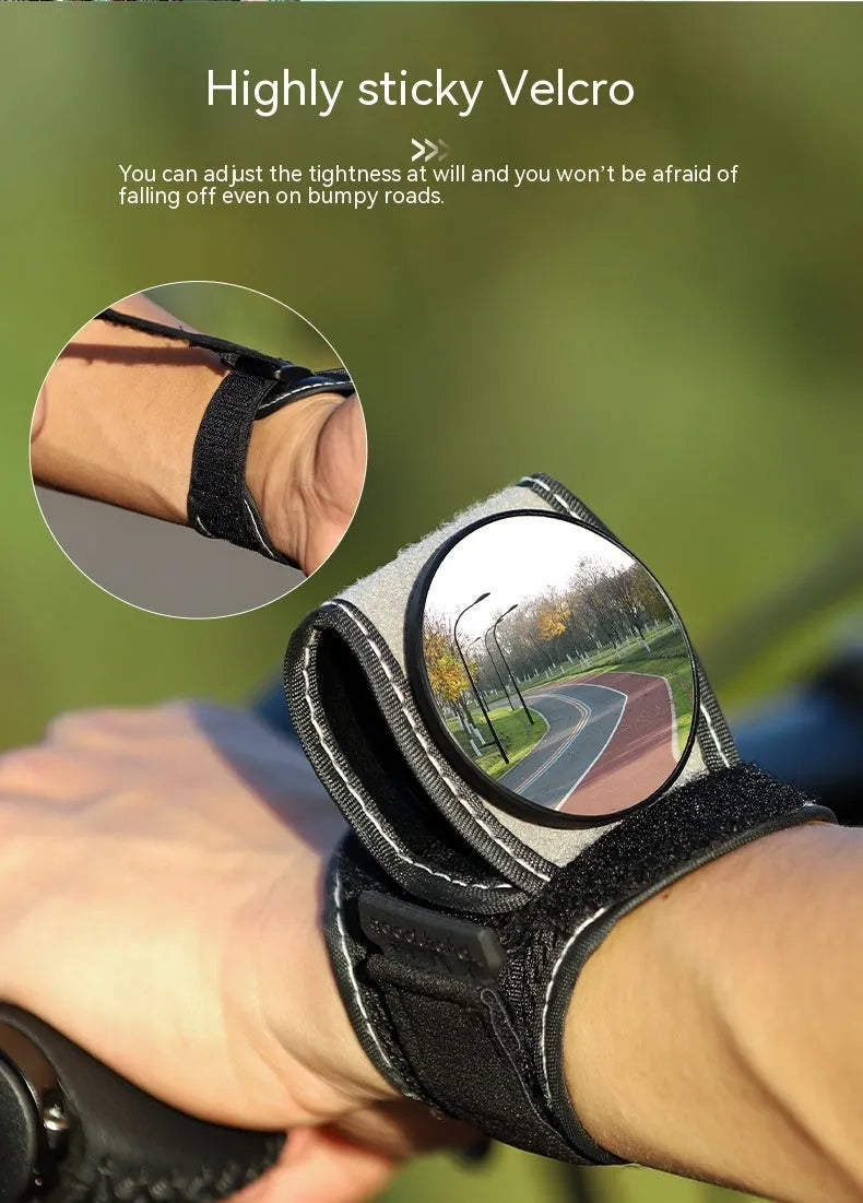 Black nylon wrist-mounted rear-view mirror for cyclists and motorcyclists on a textured background.
