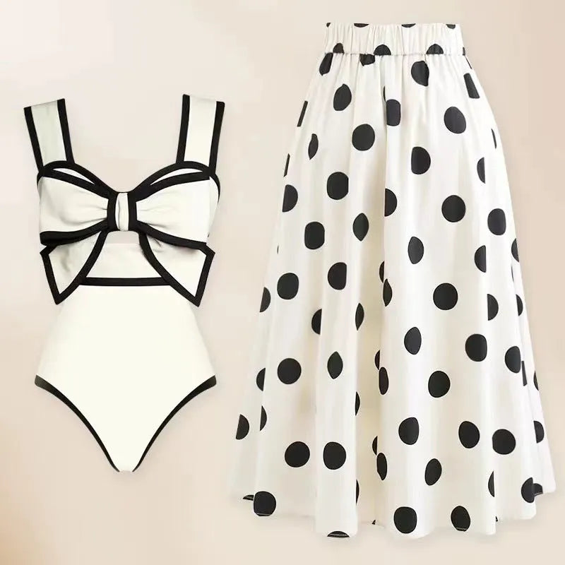 Women's black one-piece swimsuit with white attached skirt beach dress and bow trim
