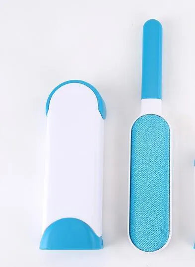 Blue reusable pet hair removal brush with a self-cleaning base, placed on a grey sofa.