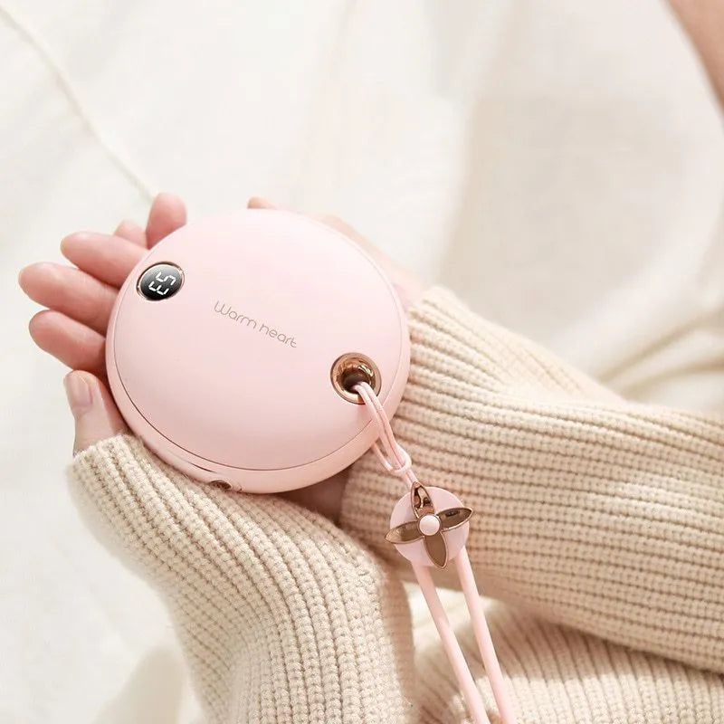Green hand warmer power bank with digital display showing battery percentage and temperature setting