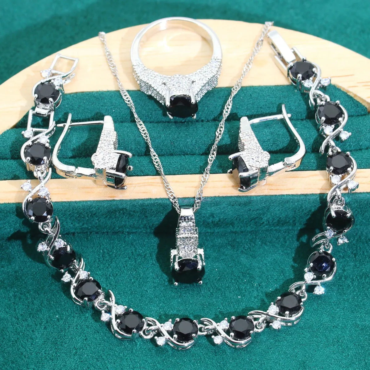 Four-piece bridal jewellery set showing zircon necklace, bracelet, earrings and ring with water wave chain design