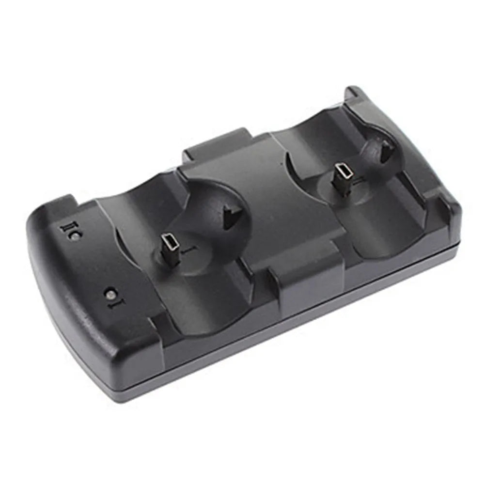 Black PS3 dual USB charging dock for two wireless controllers next to a PlayStation 3 console