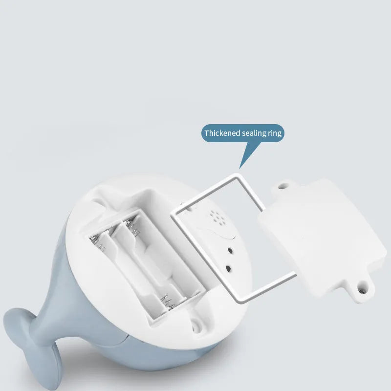 Automatic water spray whale bath toy floating in water with fountain and LED lights