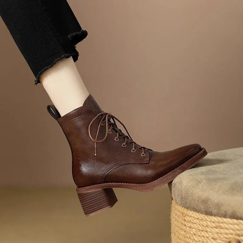 Women's black pointed toe short tube ankle boots with 5.5cm heel on wooden floor