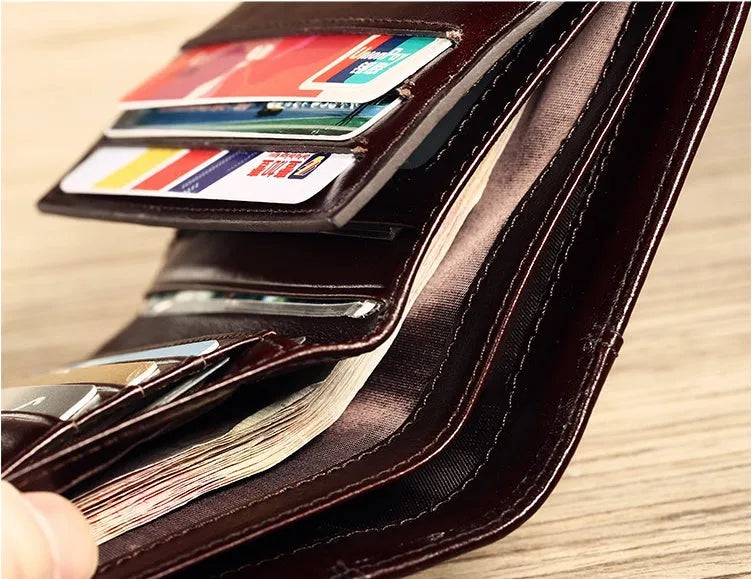 Men's genuine leather wallet open showing multiple internal compartments including card slots and secret pocket