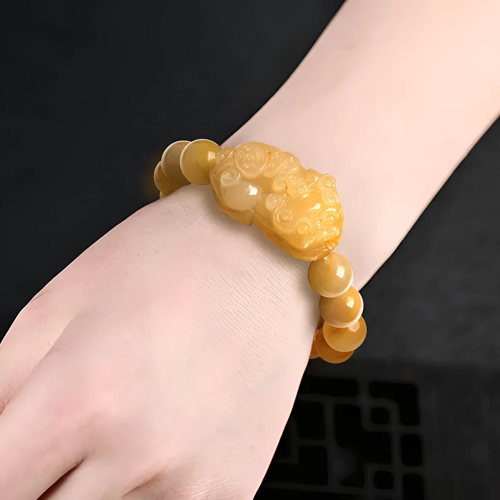 Golden thread jade bracelet with hand-carved money design showing two size options with jade beads