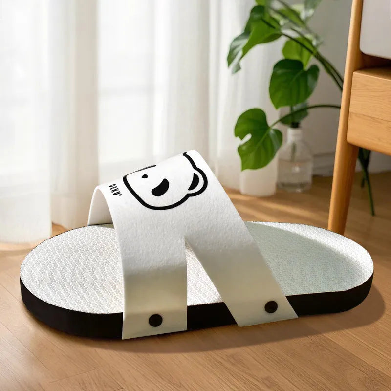 White slipper-style corrugated paper cat scratch board on floor