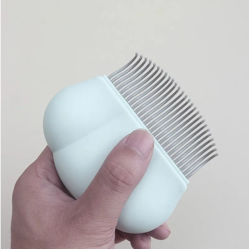 Paw Soft deshedding brush grooming tool for cats and dogs on a white surface.