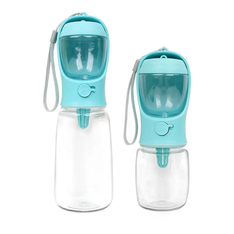 A blue portable plastic dog water bottle with an integrated flip-out drinking bowl on a green background.