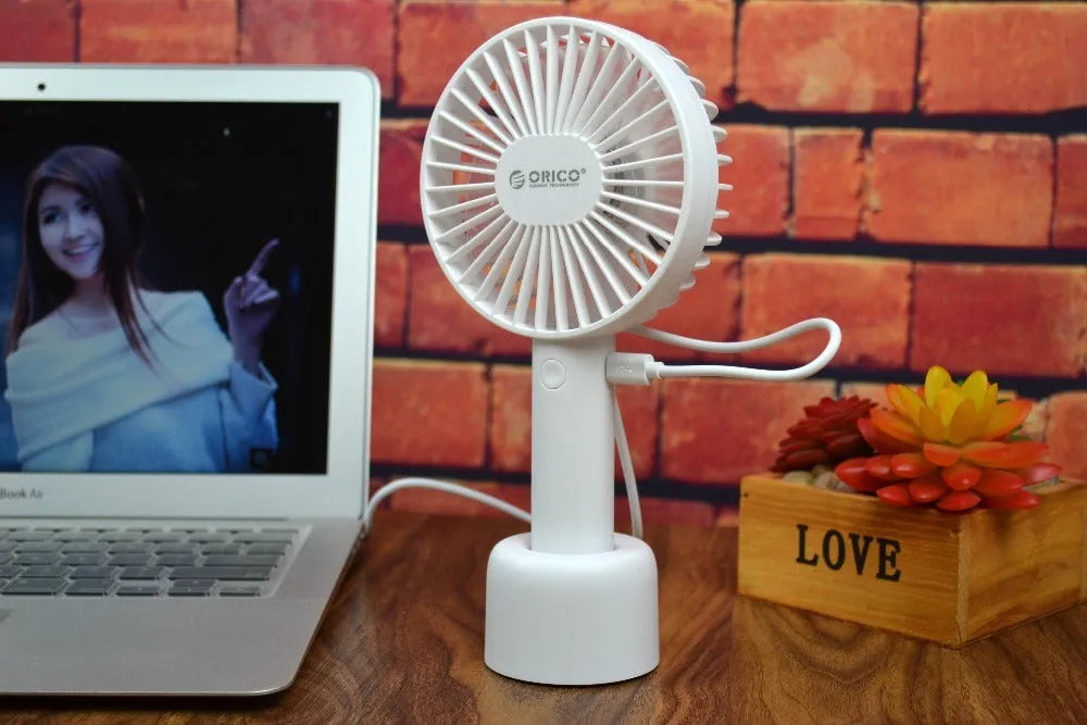 White ORICO FH1 portable USB desk fan with fine line design on a desktop.
