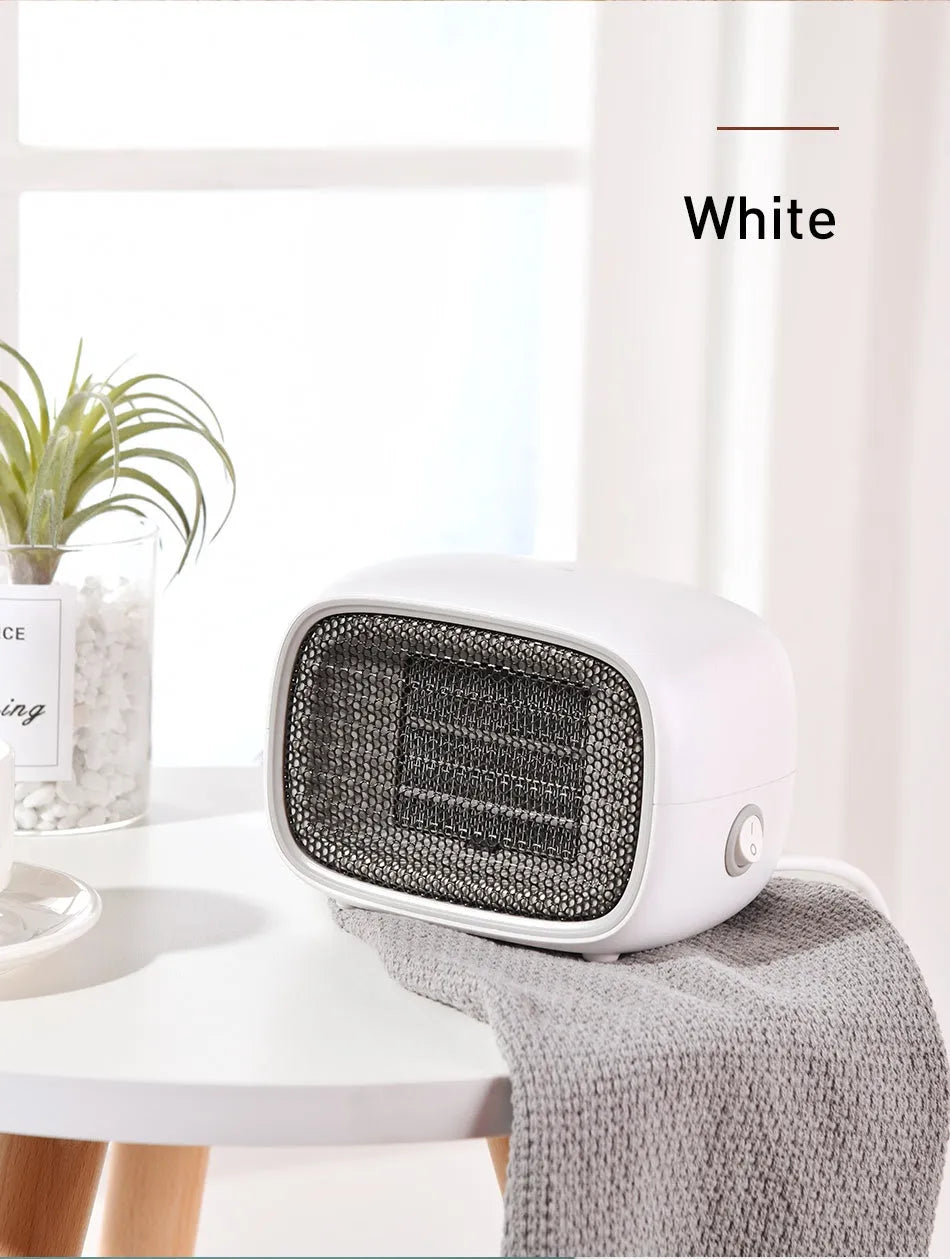 Mini ceramic desk heater in green colour showing compact dimensions