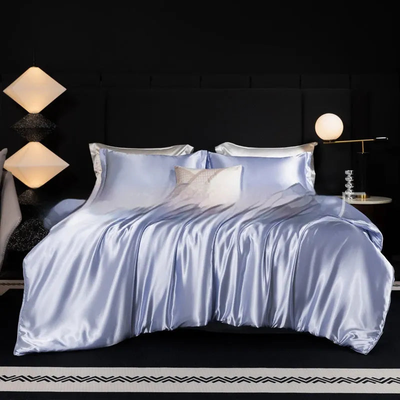 Silk bed sheet four-piece set in solid colour folded, showing options for Ash Purple, Cool Black, and Golden Camel.