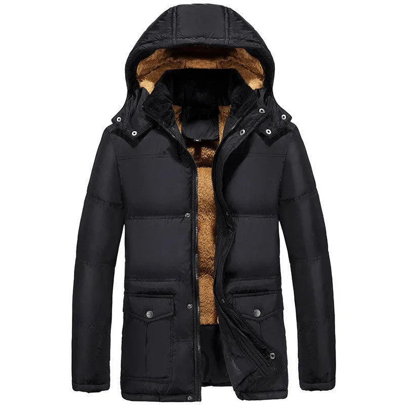 Man wearing a loose black velvet padded jacket with a double-breasted front and hood.