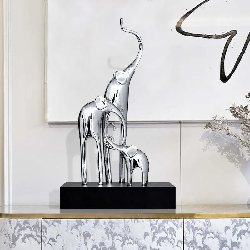 Detailed resin elephant figurine ornament in metallic gold finish on a wooden shelf.