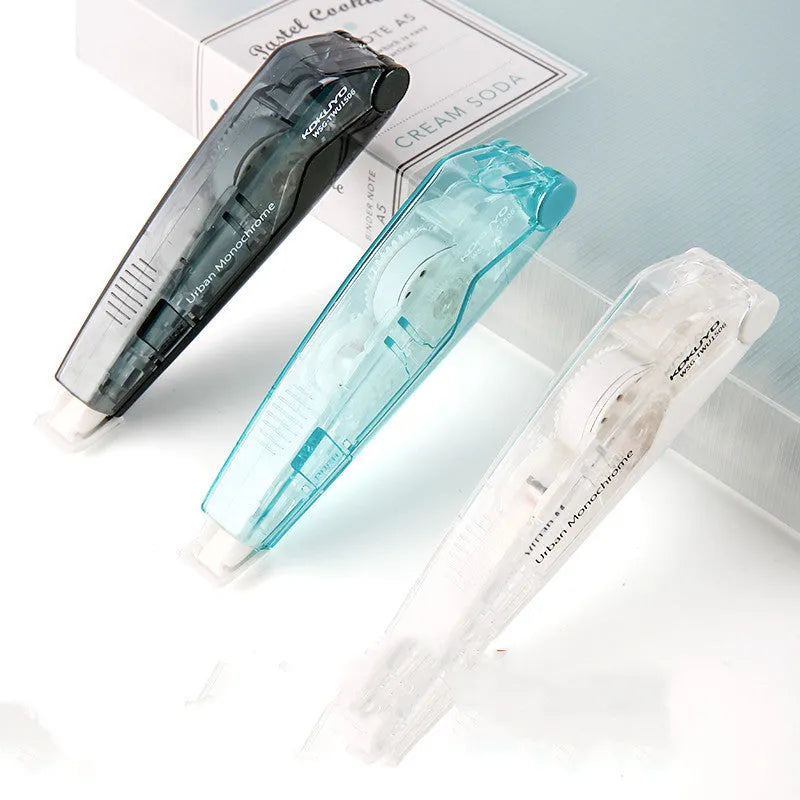 Transparent correction tape refill cartridge in blue, pink, yellow, black, and white.