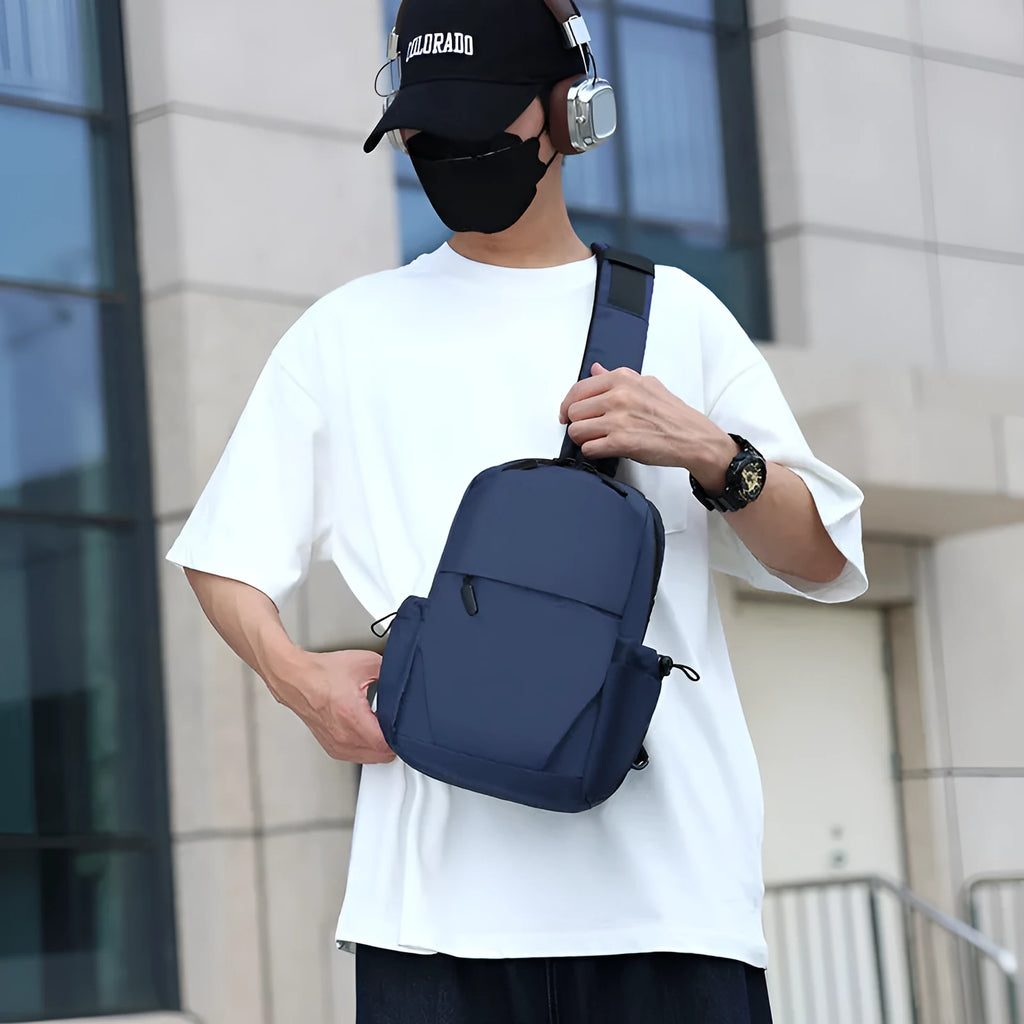Men's grey waterproof chest bag showing front view with shoulder strap and large main compartment.