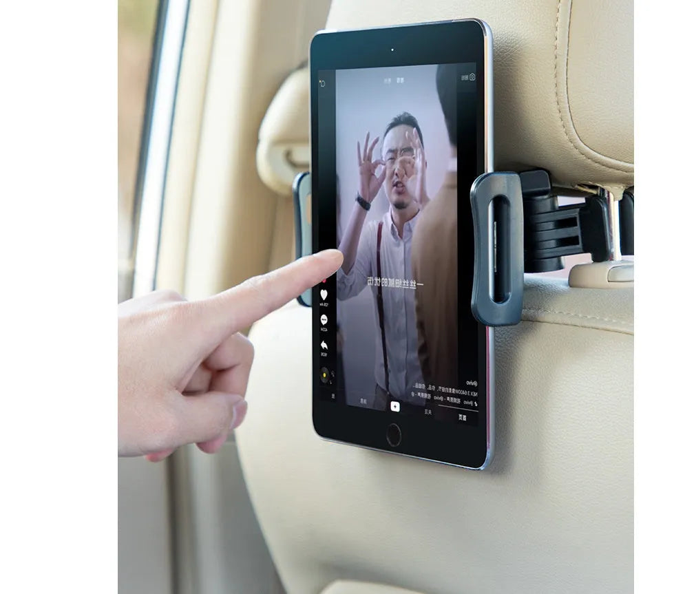 Black universal car phone holder mounted on a car rear seat base, holding a tablet for navigation