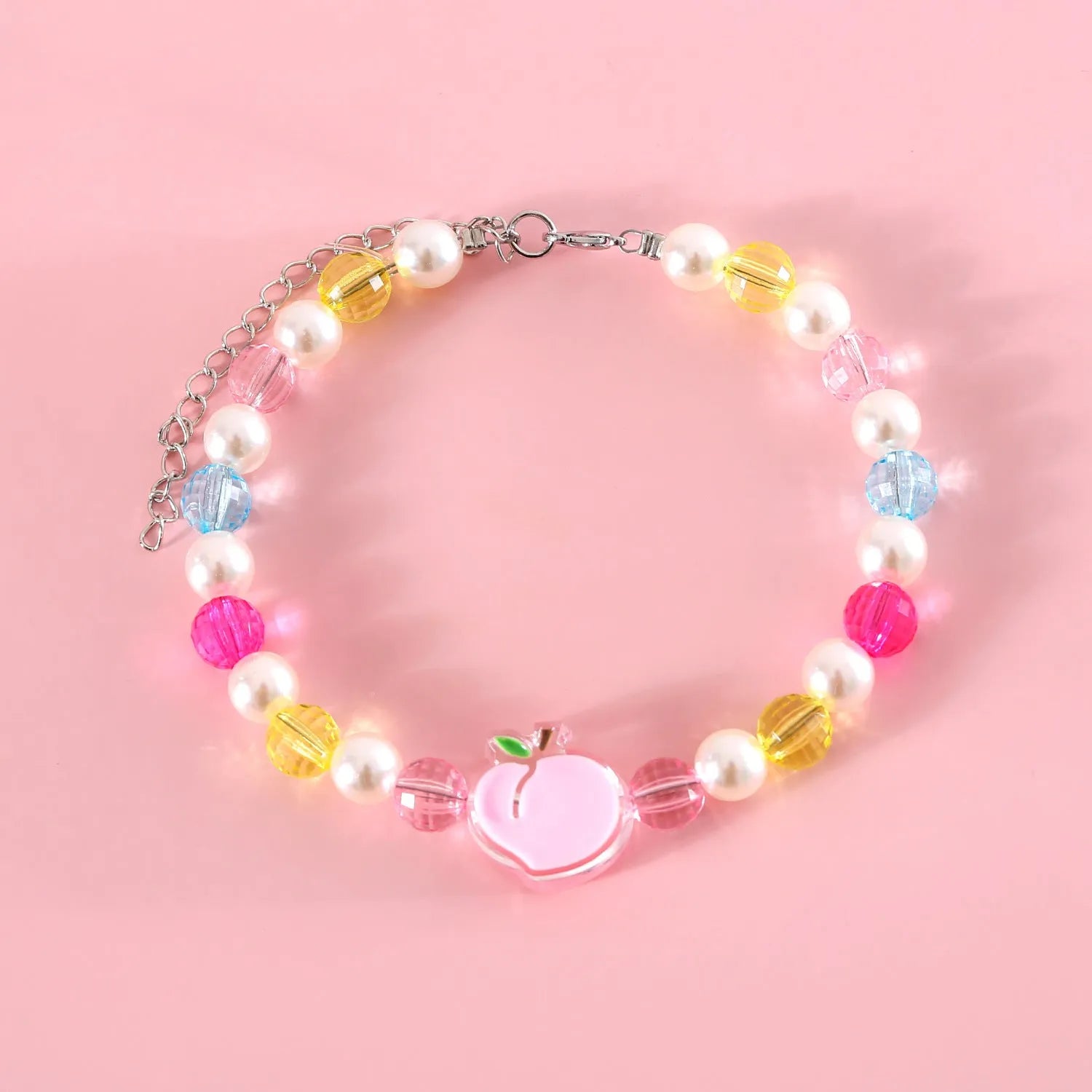 Colourful plastic bead cat necklace in small flower, rainbow, or peach design on a cat.