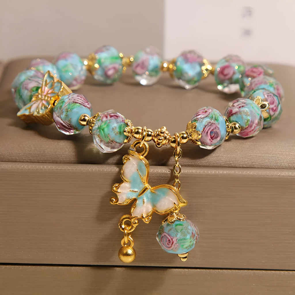 Women's rose garden bracelet with coloured glaze butterfly charm in blue, Japanese Korean style