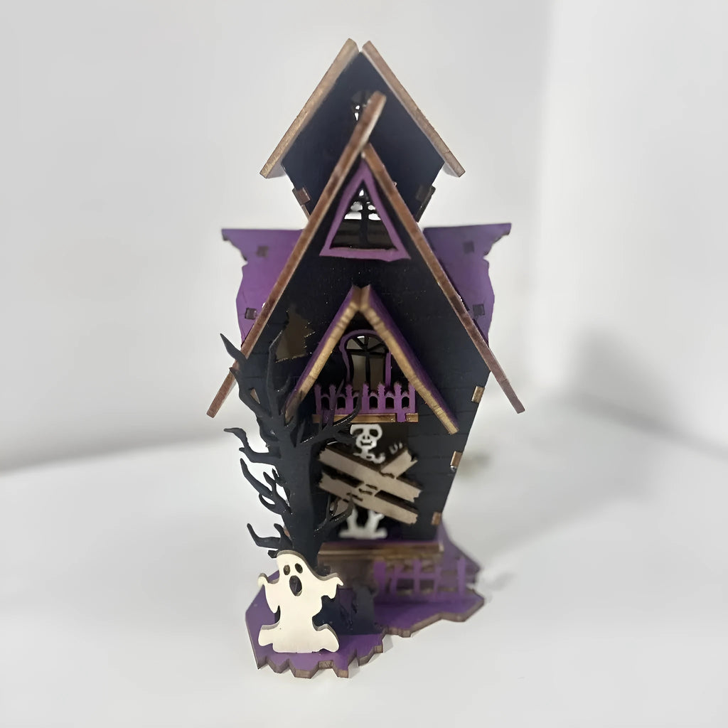 Wooden glowing haunted house Halloween table decoration on a dark surface