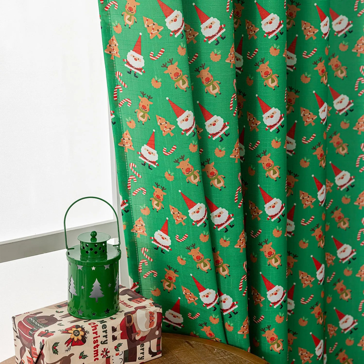 Christmas curtain with snowman and angel cartoon print in green, 1 metre length.