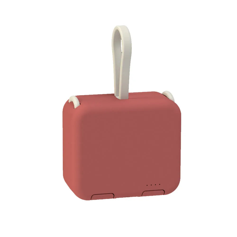 Handbag back clip power bank in blue, showing clip detail and phone standing in its holder mode.