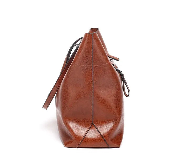 Brown wax cowhide leather handbag showing internal compartments and crossbody strap