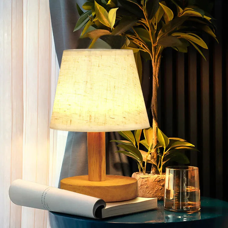 Vintage pleated table lamp with jute and linen shade on bamboo base, featuring USB charging and three-colour dimming.