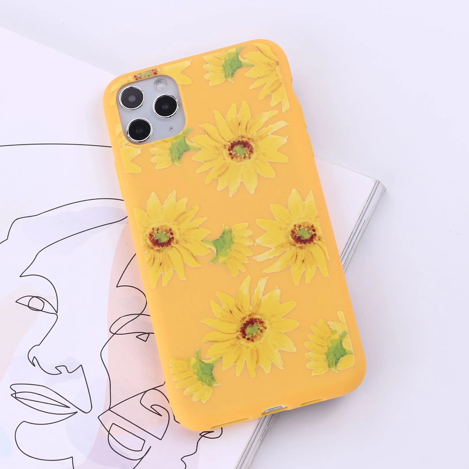 Slim TPU mobile phone case for iPhone on a table, showing one of 14 available colour options.