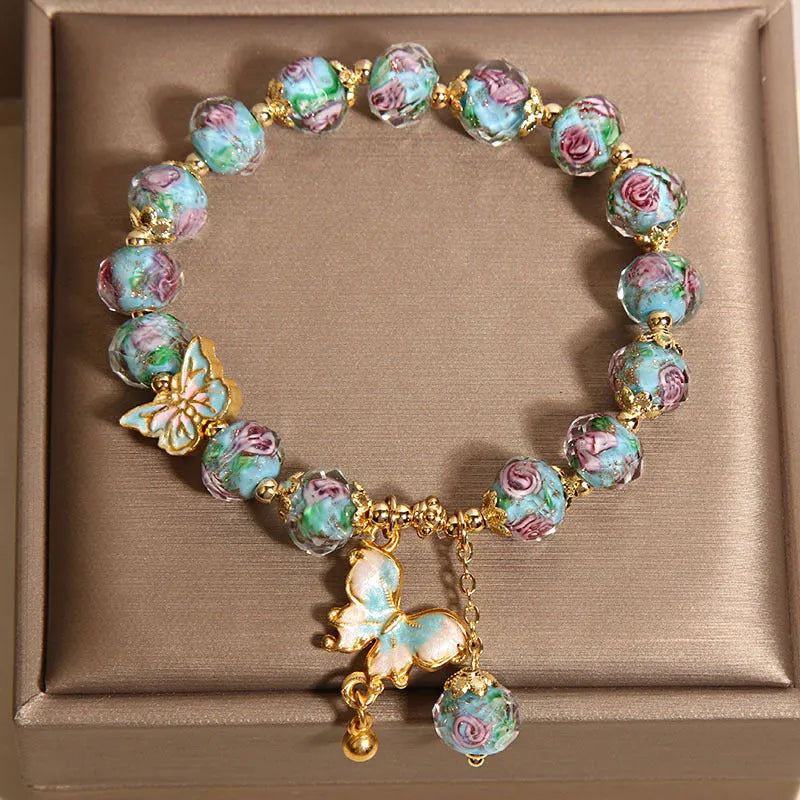 Women's rose garden bracelet with coloured glaze butterfly charm in blue, Japanese Korean style