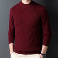Man wearing a thick grey diamond jacquard knit pullover sweater.