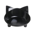 White shallow melamine cat bowl with non-slip rubber base on a wooden table.