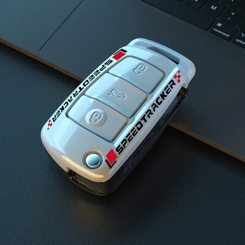 Car key cover with carbon fibre texture and mirrored detailing, white colour option shown alongside