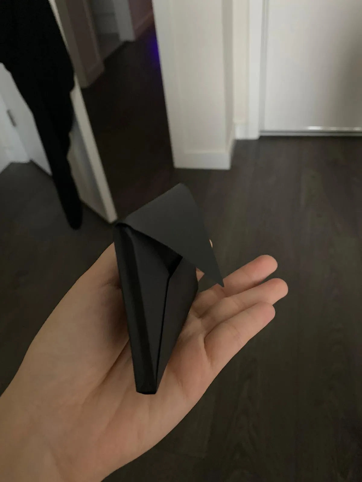 Plain black mailing envelope measuring 9 cm by 6 cm, shown flat with a flap