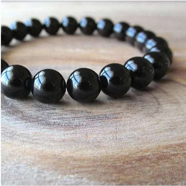 Geometric black agate bead bracelet for women with 8mm stones on a stretch elastic cord.
