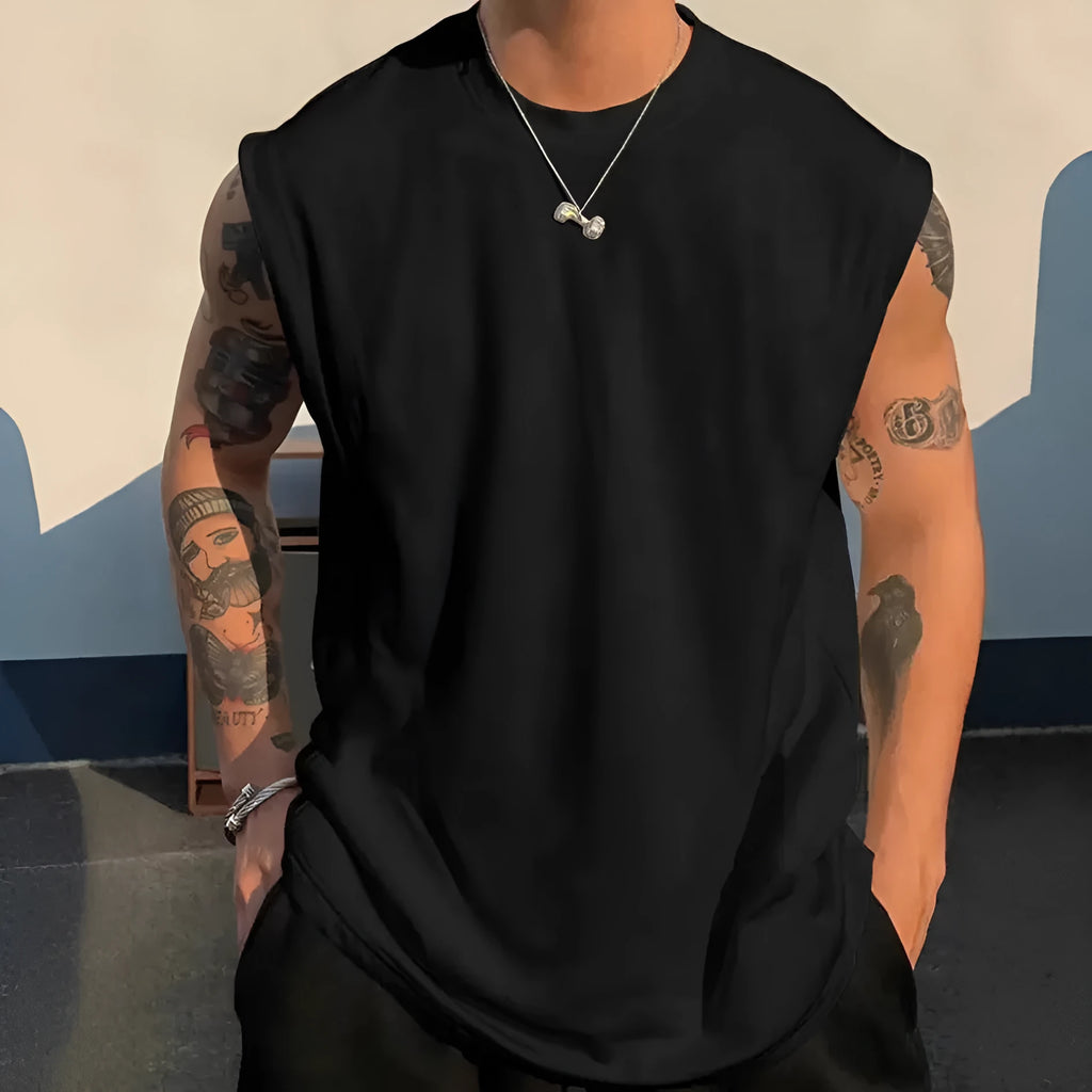 Men's loose solid colour sleeveless cotton tank top on a hanger, shown in a light apricot shade.