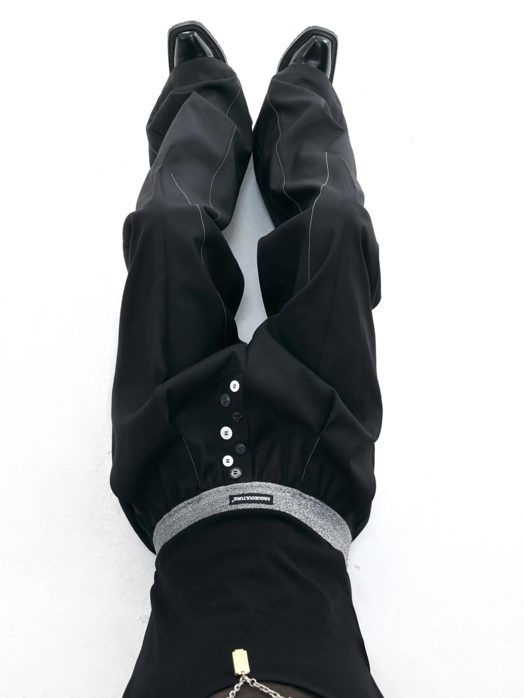 Straight-leg high-waist trousers with button-fly front opening in black or grey