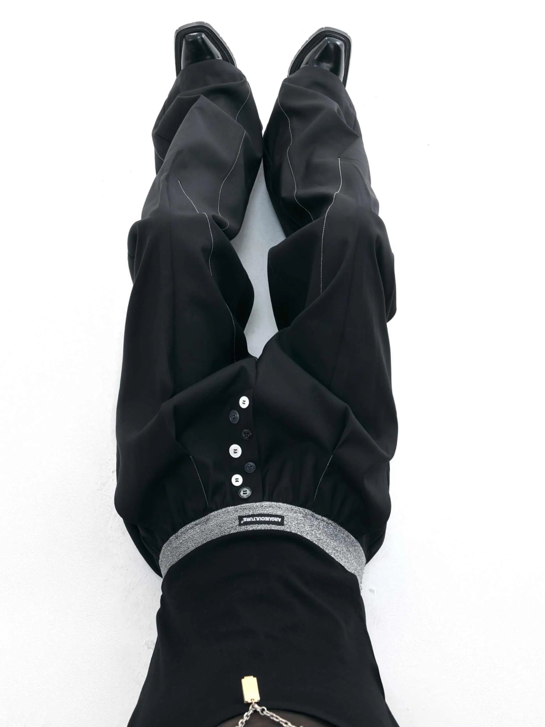 Straight-leg high-waist trousers with button-fly front opening in black or grey